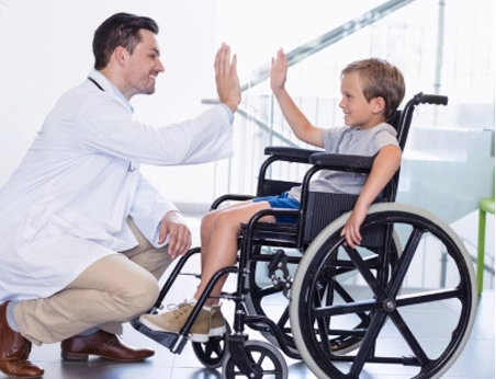 Doctor examining a child for cerebral palsy therapy.